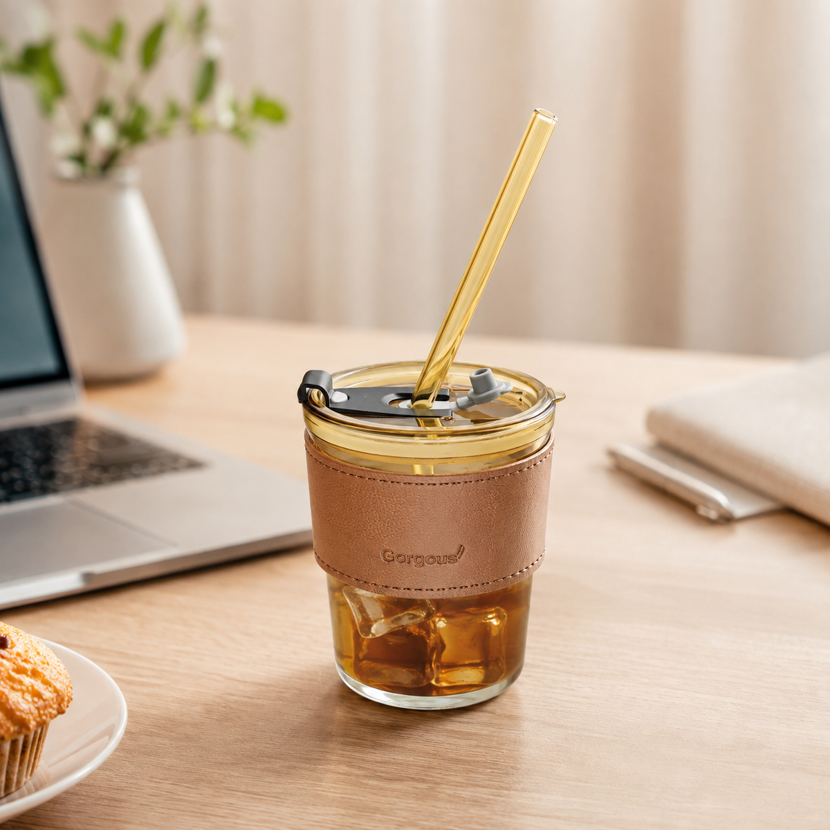 Amber glass coffee mug with straw and leather sleeve