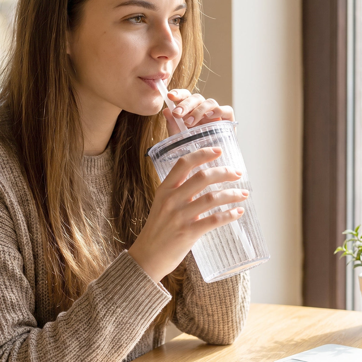 Plastic tumbler filled with a beverage